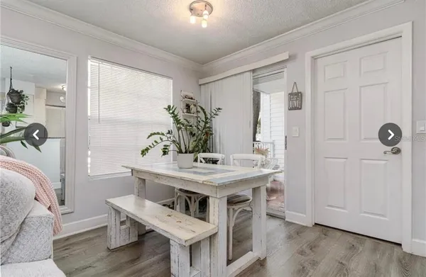 a view of a kitchen area with furniture and wooden floor