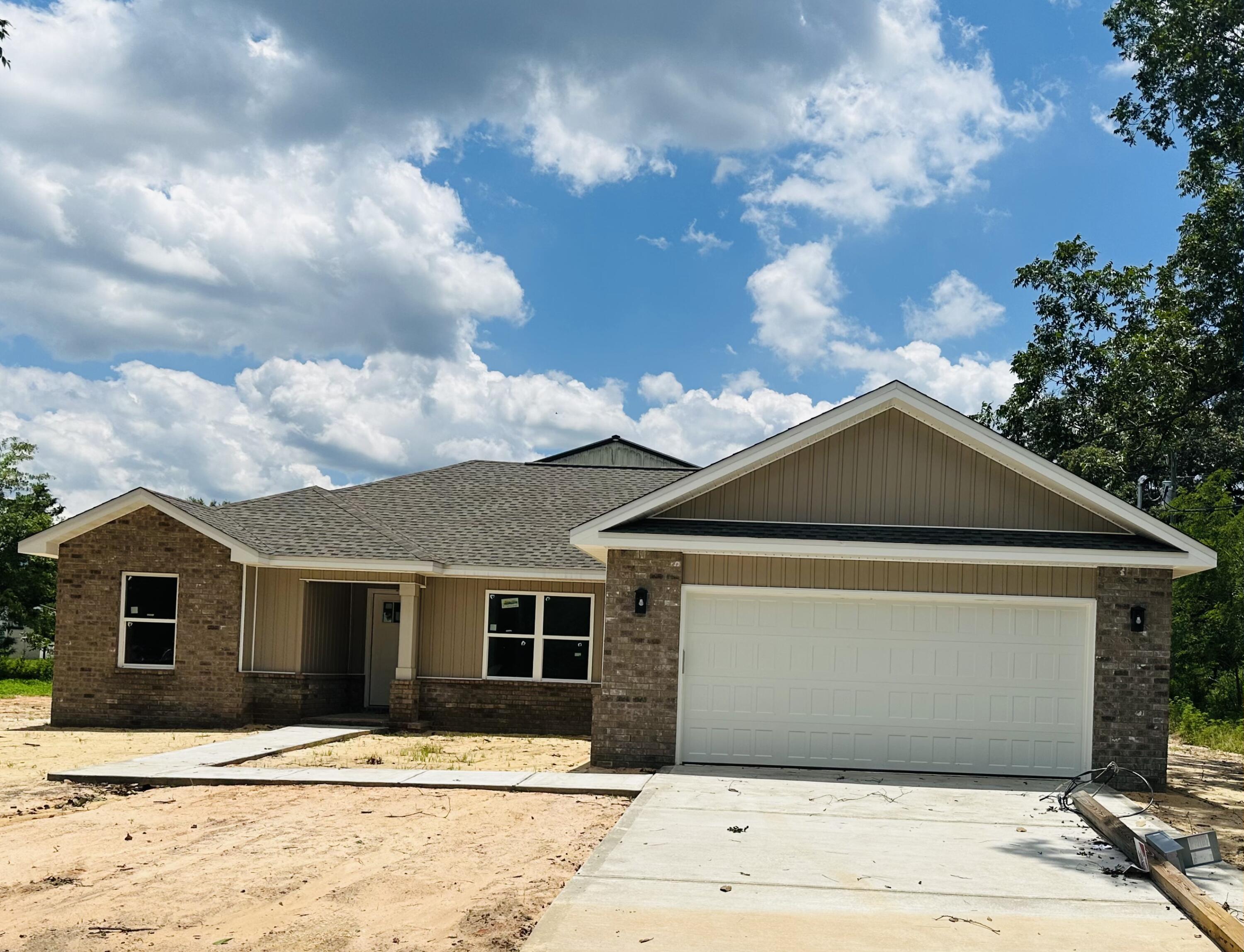 3028 Adams Road Crestview, FL 32536 - Photo 3 of 6 a front view of a house with a yard
