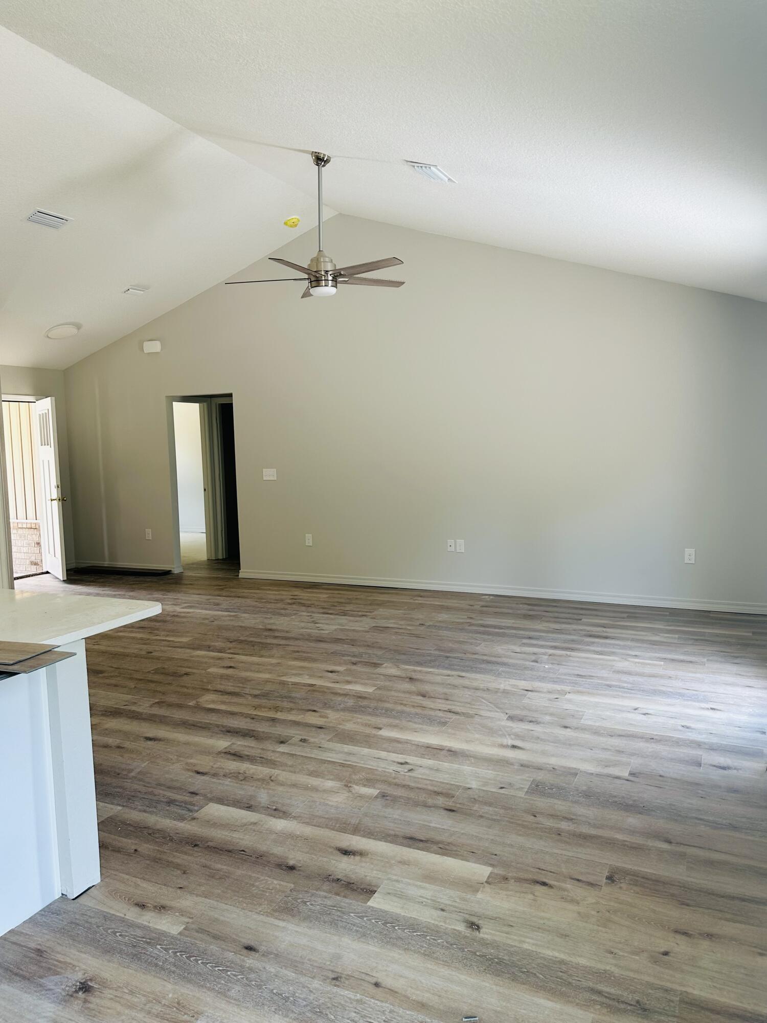 3028 Adams Road Crestview, FL 32536 - Photo 6 of 6 a view of an empty room with wooden floor