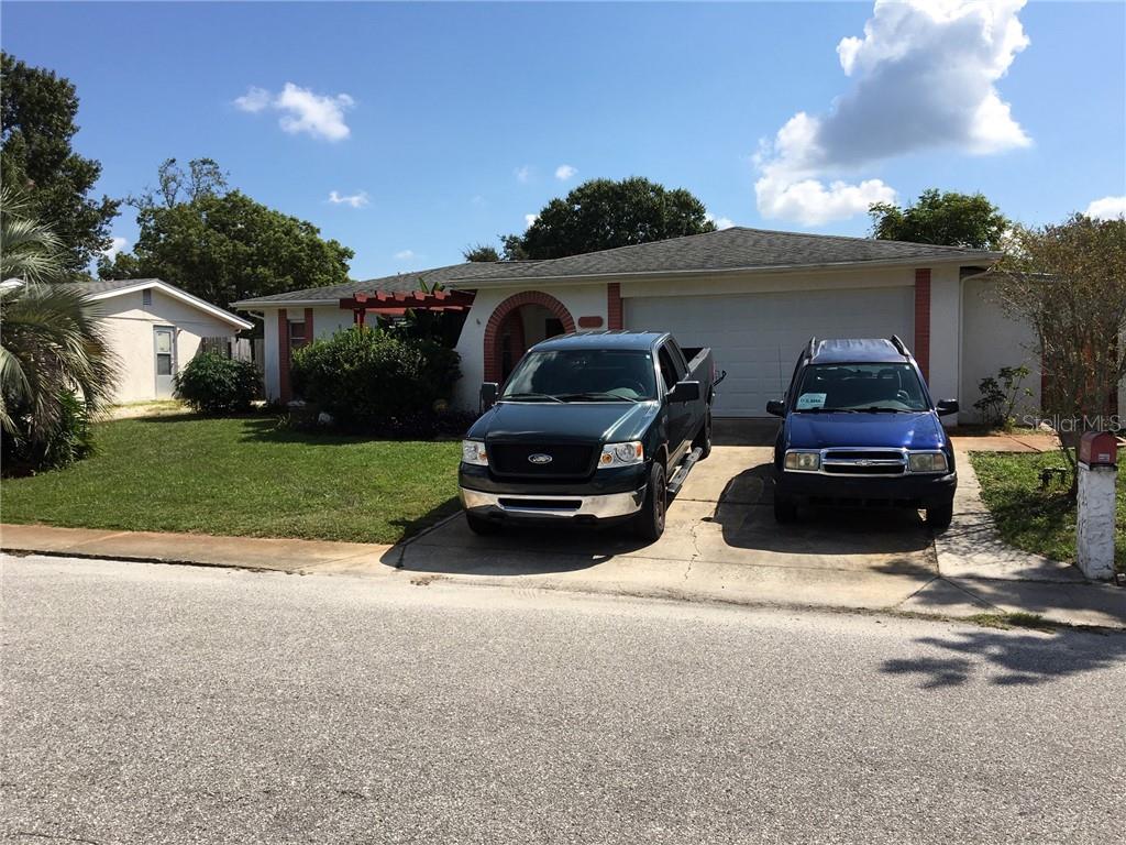 9110 Prosperity Lane Port Richey, FL 34668 - Photo 1 of 1 a car parked in front of a house