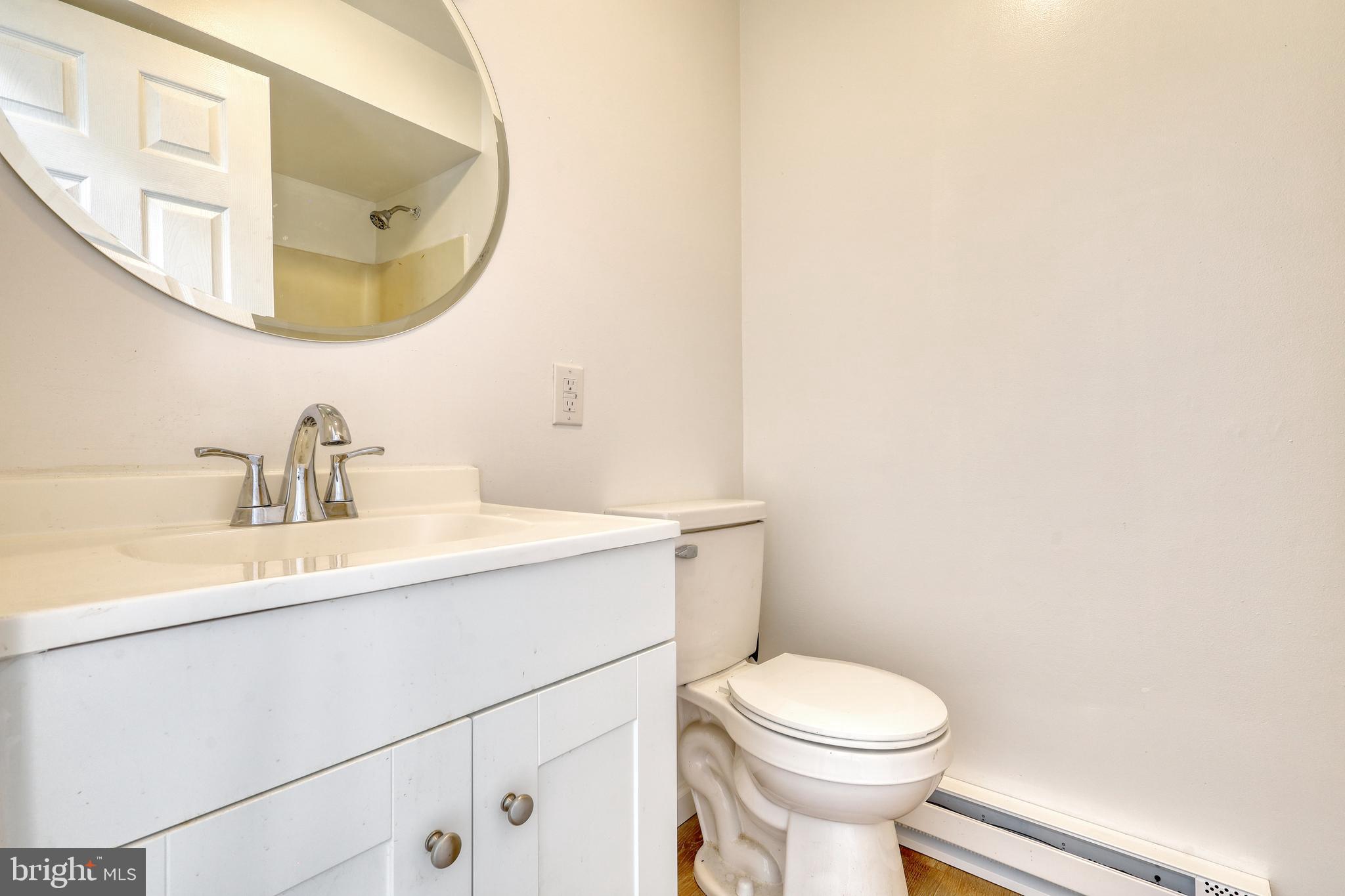125 Ramblewood Road Pennsylvania Furnace, PA 16865 - Photo 12 of 36 a white toilet sitting next to a bathroom sink