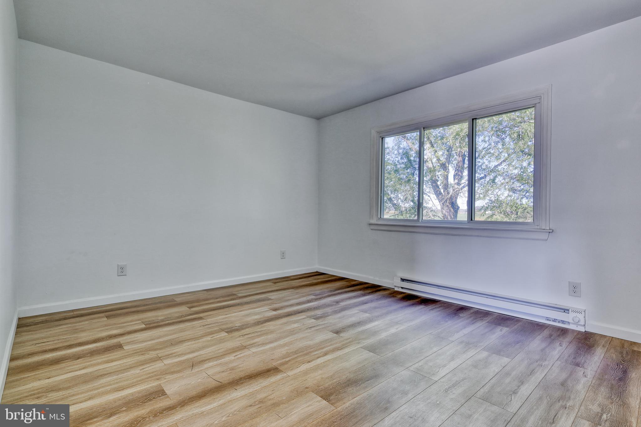 125 Ramblewood Road Pennsylvania Furnace, PA 16865 - Photo 14 of 36 a view of an empty room with wooden floor and a window