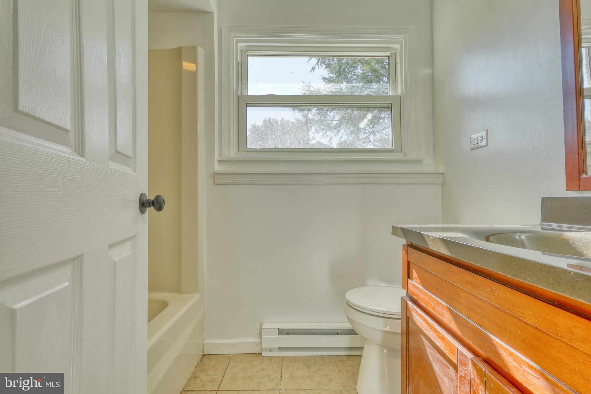 125 Ramblewood Road Pennsylvania Furnace, PA 16865 - Photo 22 of 36 a bathroom with a granite countertop sink toilet and shower