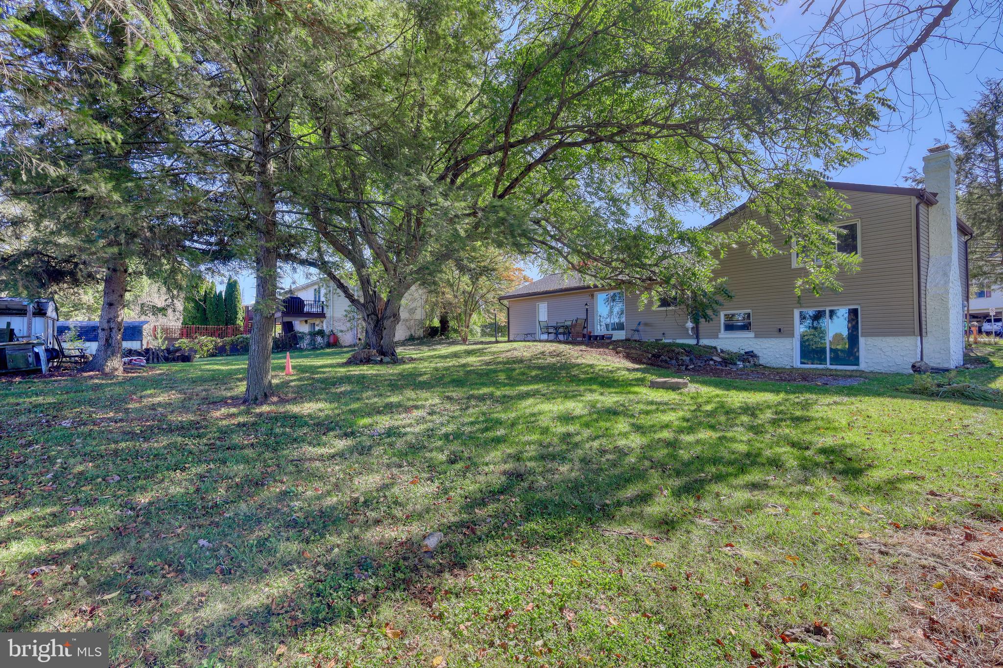 125 Ramblewood Road Pennsylvania Furnace, PA 16865 - Photo 31 of 36 a view of an house with backyard space and tree