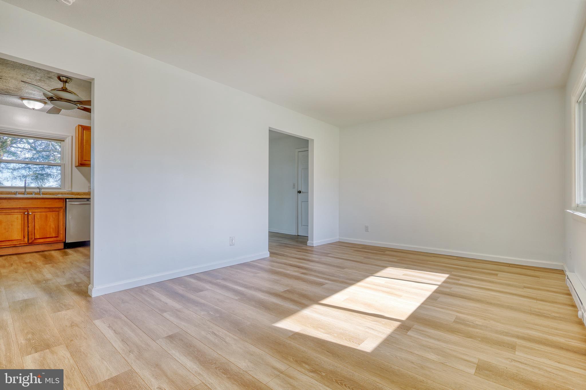 125 Ramblewood Road Pennsylvania Furnace, PA 16865 - Photo 4 of 36 an empty room with wooden floor and windows