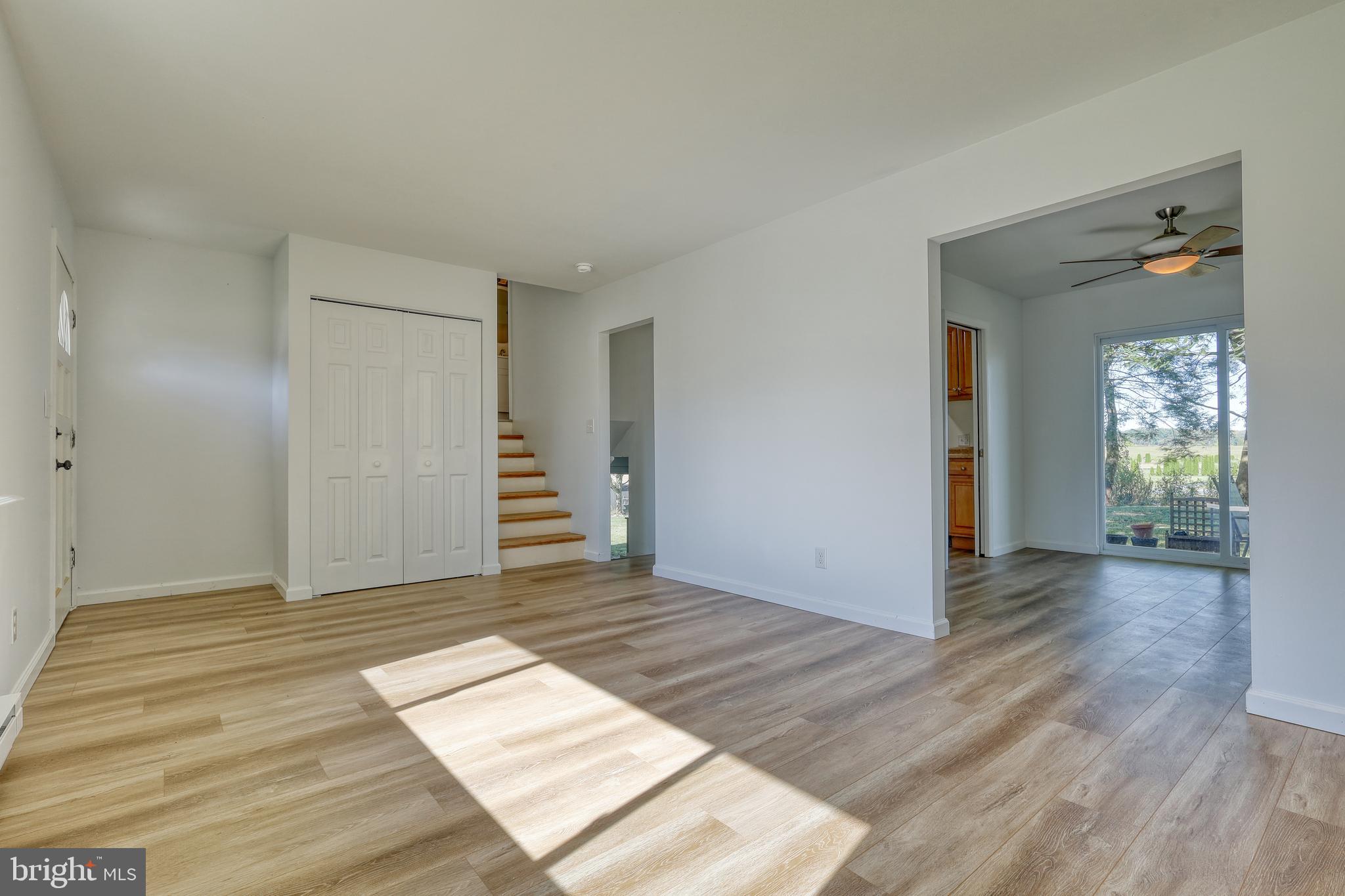 125 Ramblewood Road Pennsylvania Furnace, PA 16865 - Photo 5 of 36 an empty room with wooden floor and windows