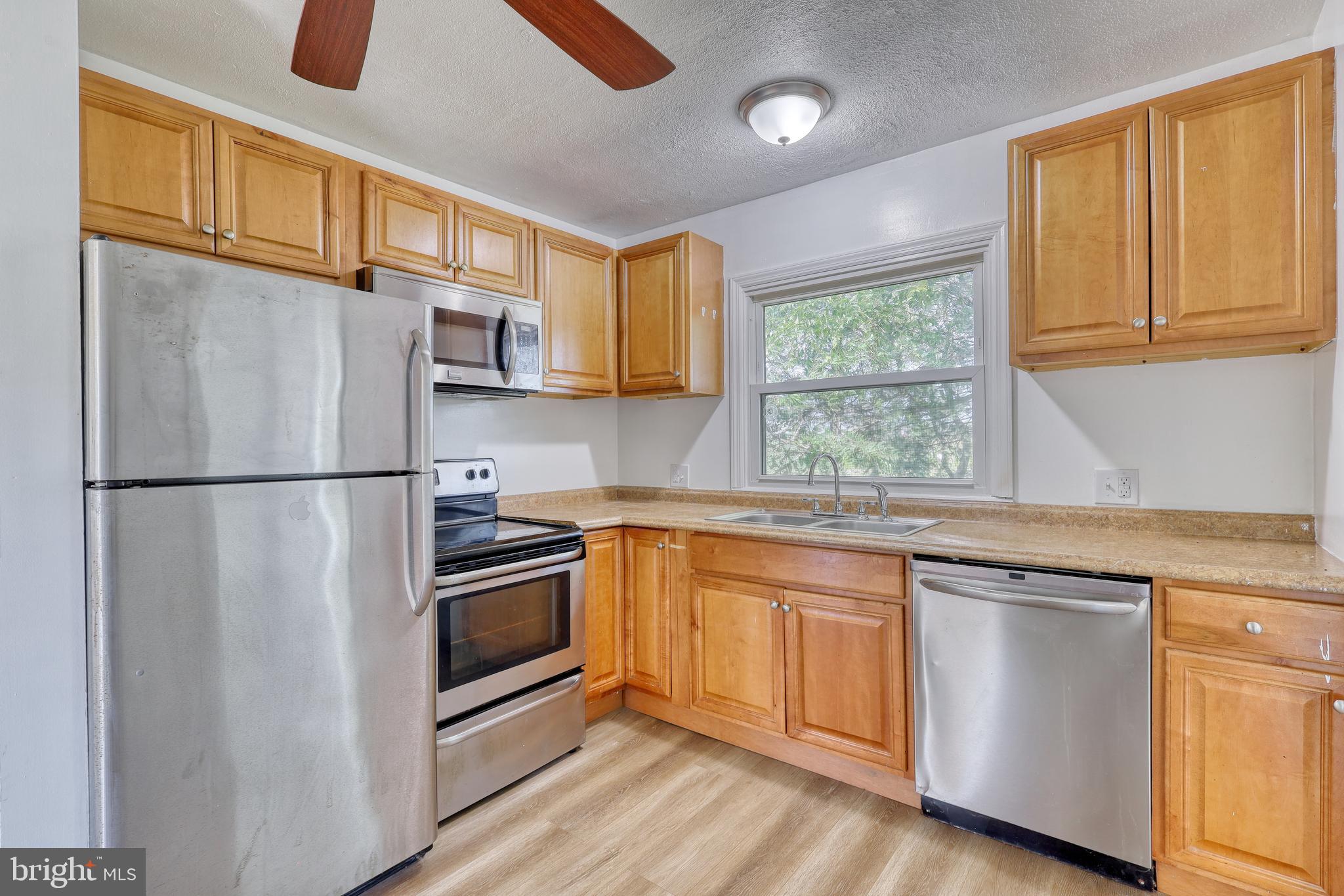 125 Ramblewood Road Pennsylvania Furnace, PA 16865 - Photo 10 of 36 a kitchen with granite countertop stainless steel appliances a refrigerator cabinets and a sink