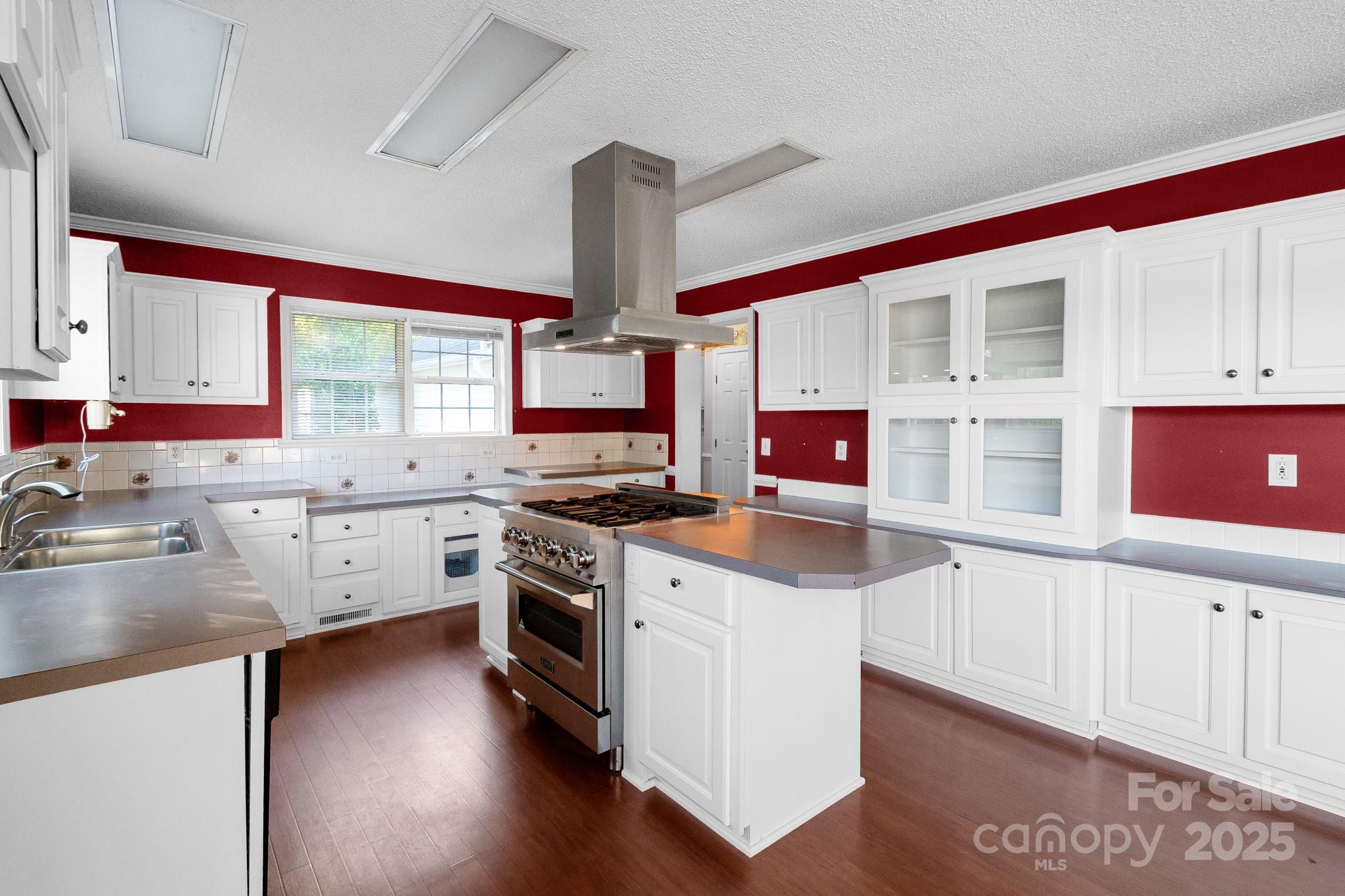2716 Camp Creek Road Lancaster, SC 29720 - Photo 29 of 47 a kitchen with stainless steel appliances granite countertop a stove a sink and white cabinets