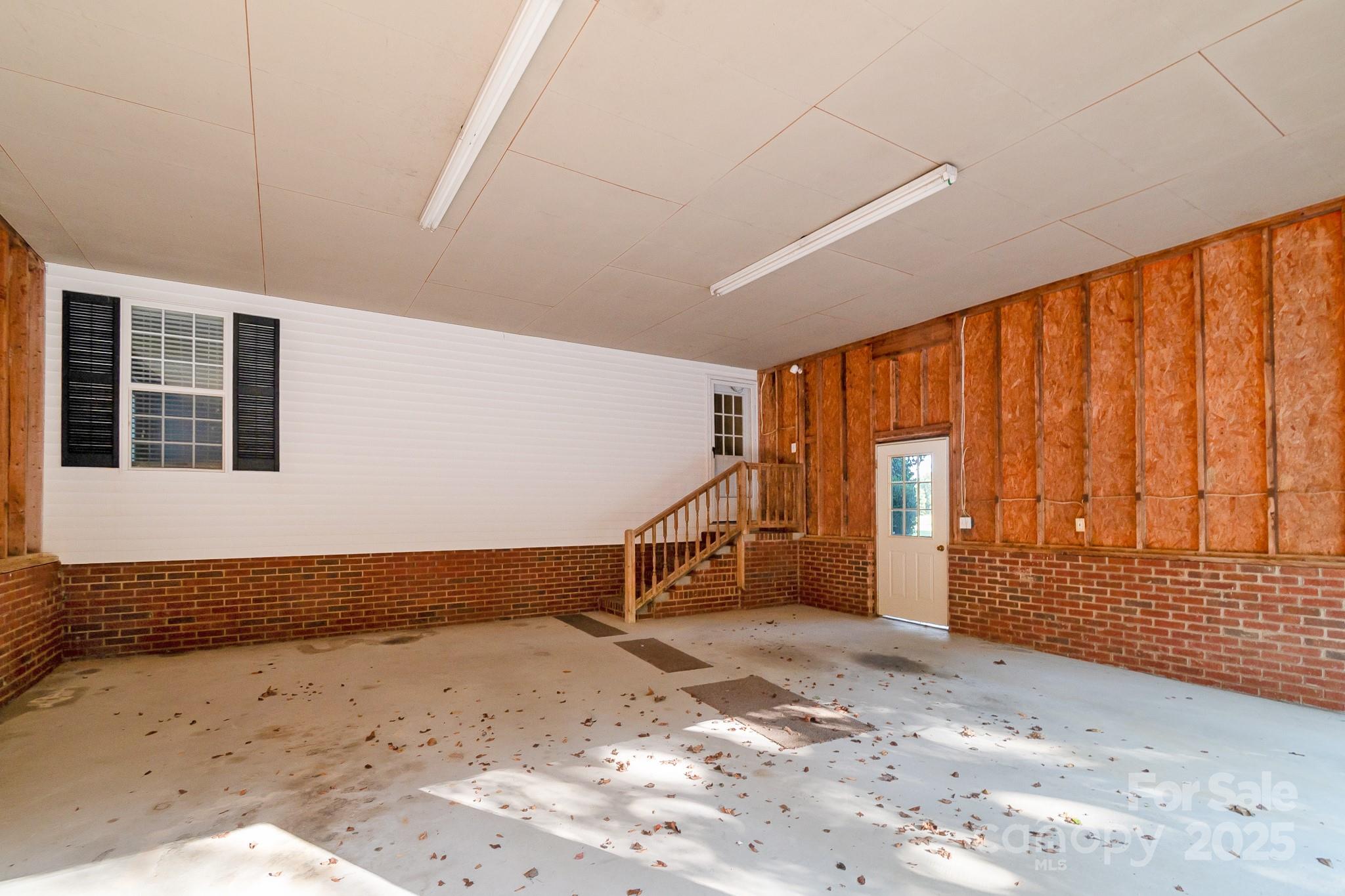 2716 Camp Creek Road Lancaster, SC 29720 - Photo 5 of 47 a view of a room with wooden walls and stairs