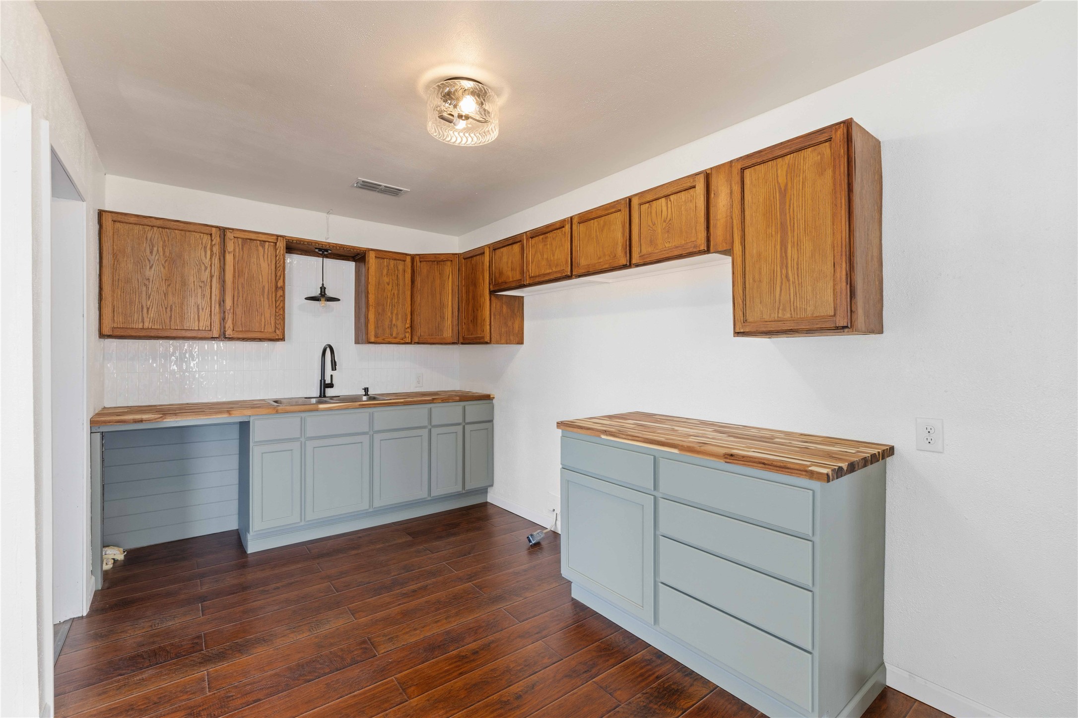 1604 5th Street Goldthwaite, TX 76844 - Photo 11 of 23 a kitchen with a cabinets and wooden floor