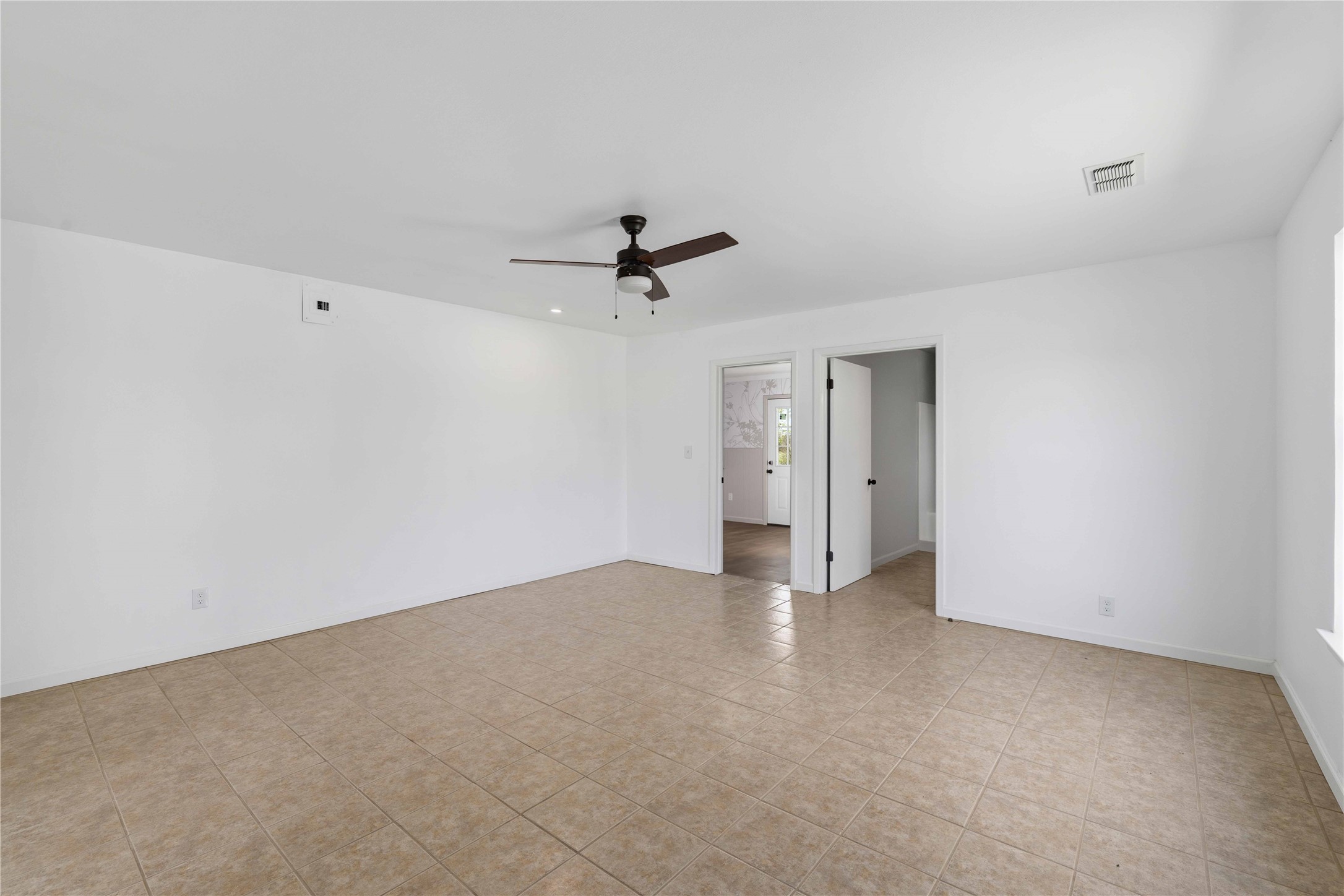 1604 5th Street Goldthwaite, TX 76844 - Photo 12 of 23 an empty room with a ceiling fan and a window