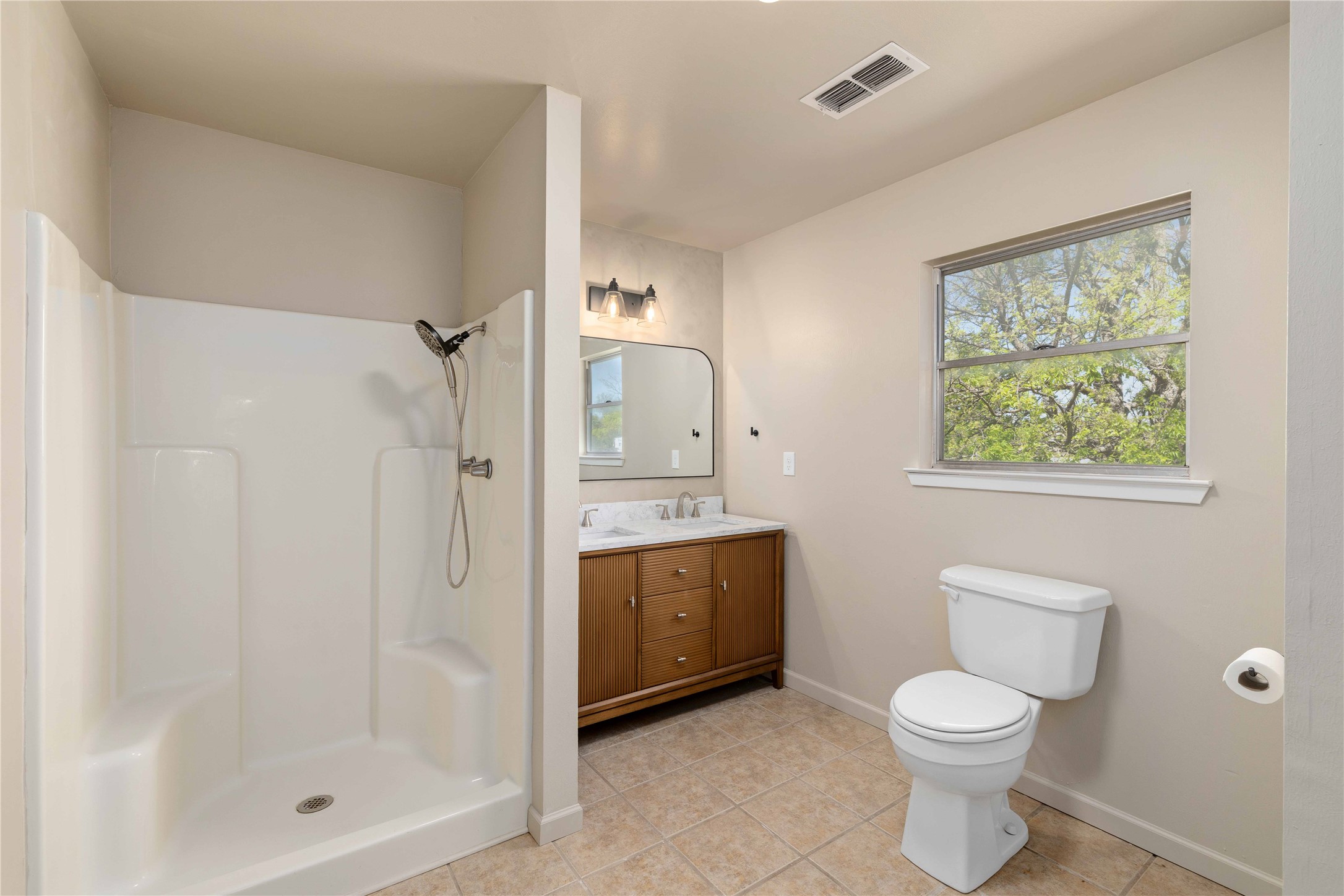 1604 5th Street Goldthwaite, TX 76844 - Photo 15 of 23 a bathroom with a toilet a sink and shower