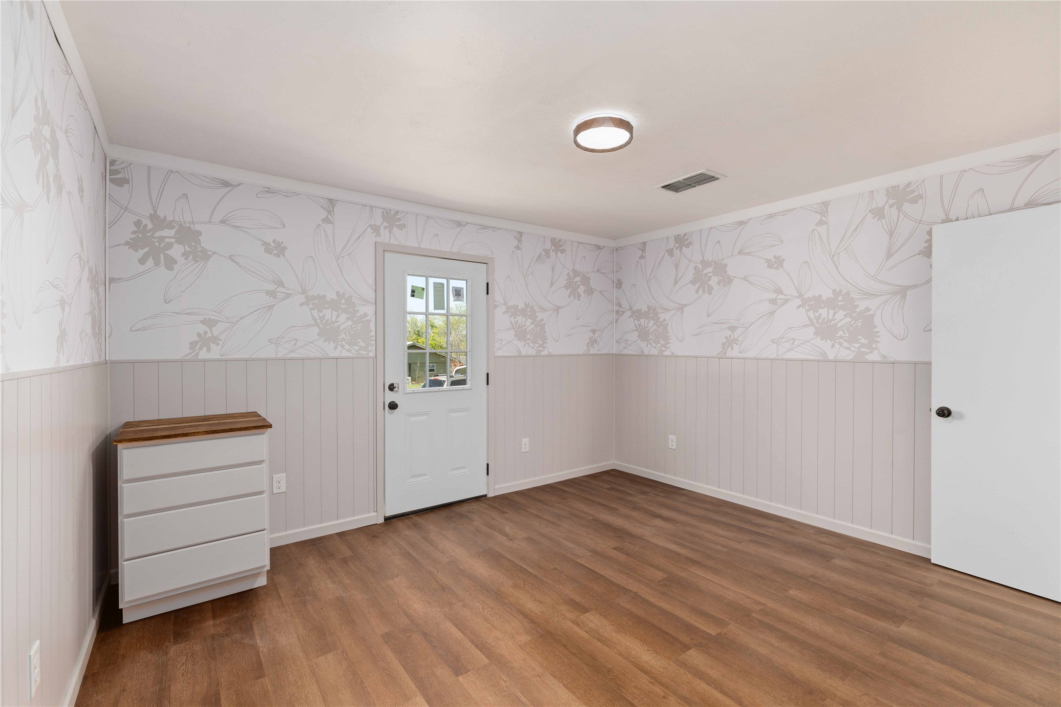 1604 5th Street Goldthwaite, TX 76844 - Photo 20 of 23 a view of empty room with wooden floor and fan