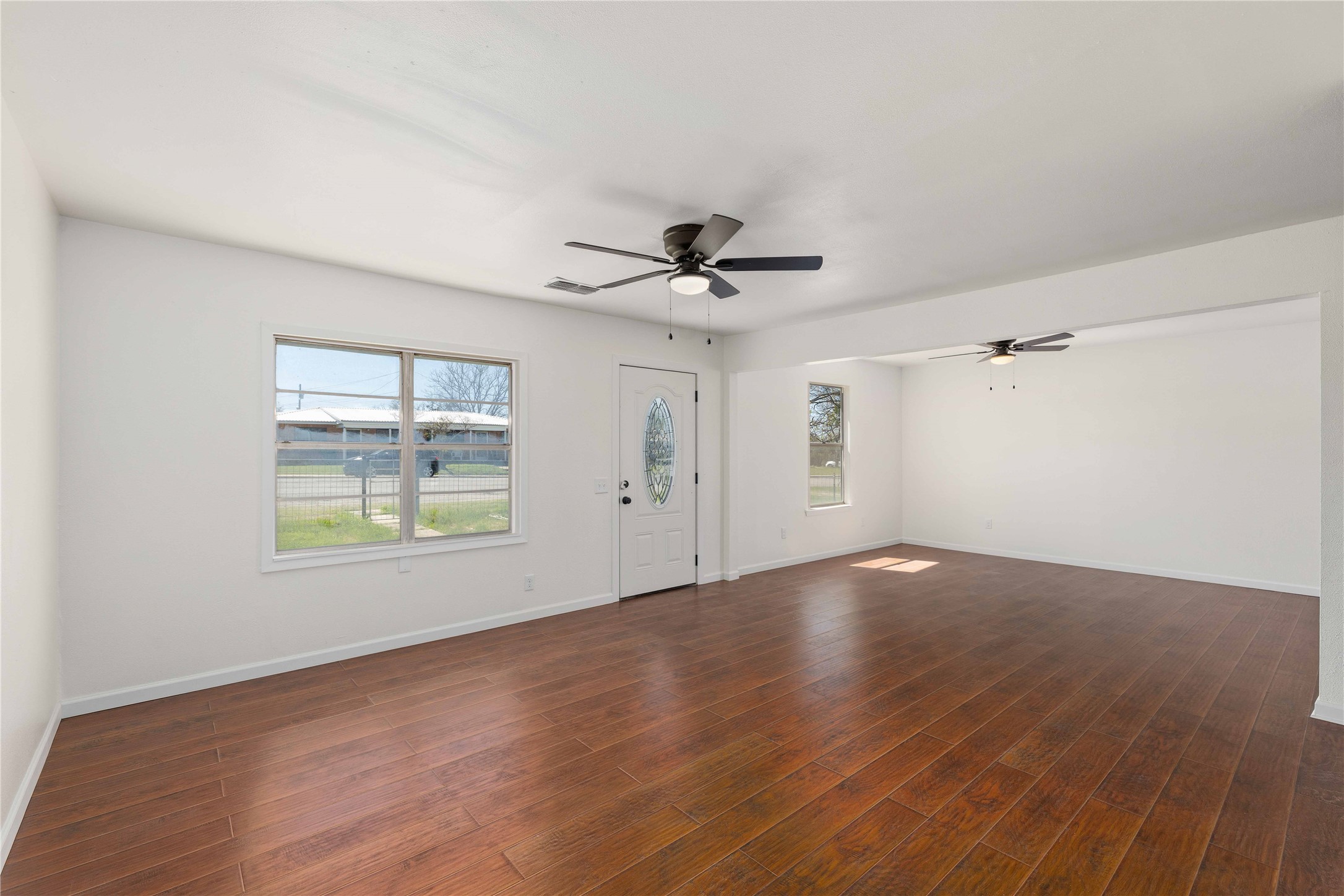 1604 5th Street Goldthwaite, TX 76844 - Photo 22 of 23 wooden floor in an empty room with a window