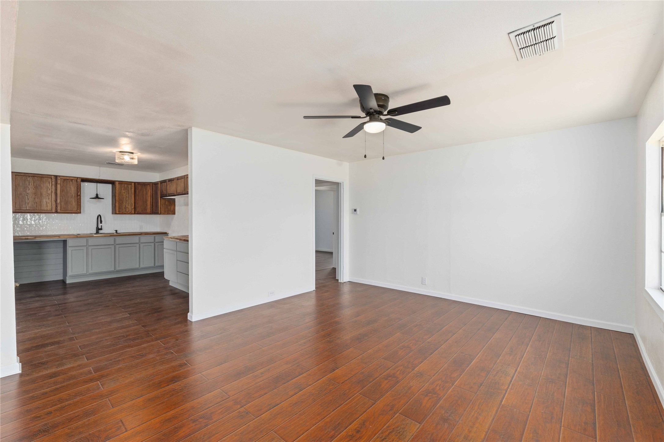 1604 5th Street Goldthwaite, TX 76844 - Photo 23 of 23 a view of a big room with wooden floor and a kitchen