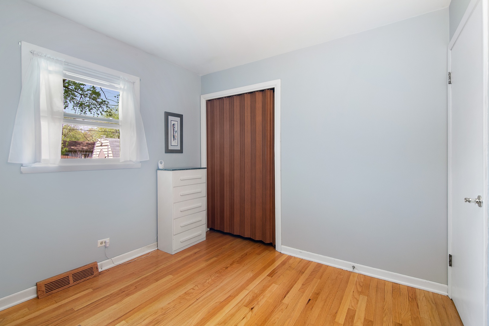 936 Pebble Drive Wheeling, IL 60090 - Photo 13 of 27 an empty room with wooden floor and window