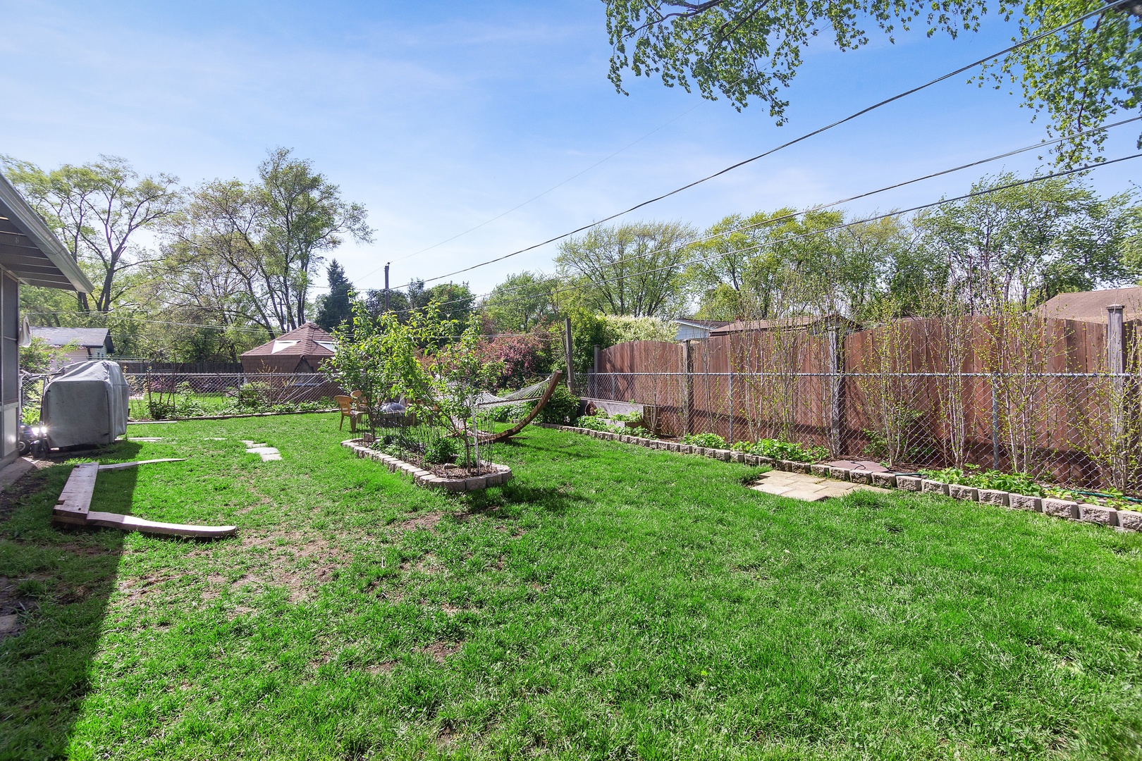 936 Pebble Drive Wheeling, IL 60090 - Photo 21 of 27 a garden with trees in front of it