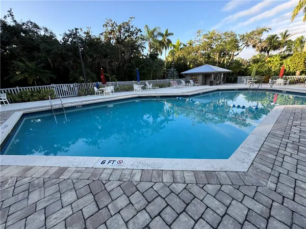a view of a swimming pool with an outdoor seating
