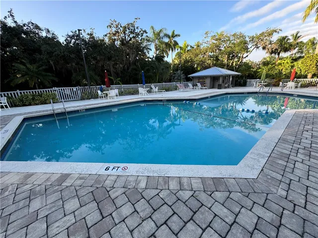 a view of a swimming pool with an outdoor seating