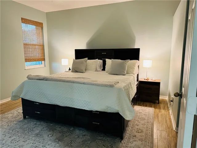 a bedroom with a bed and a night stand