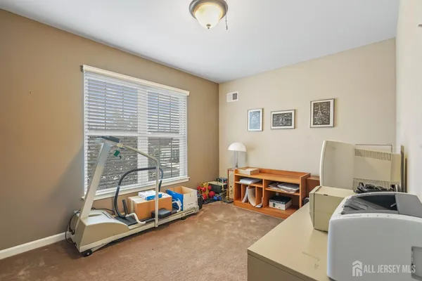 a spacious bedroom with a bed a couch and a window