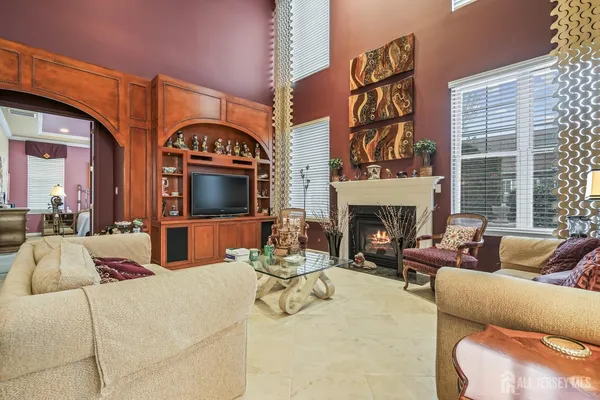 a living room with furniture a fireplace and a table