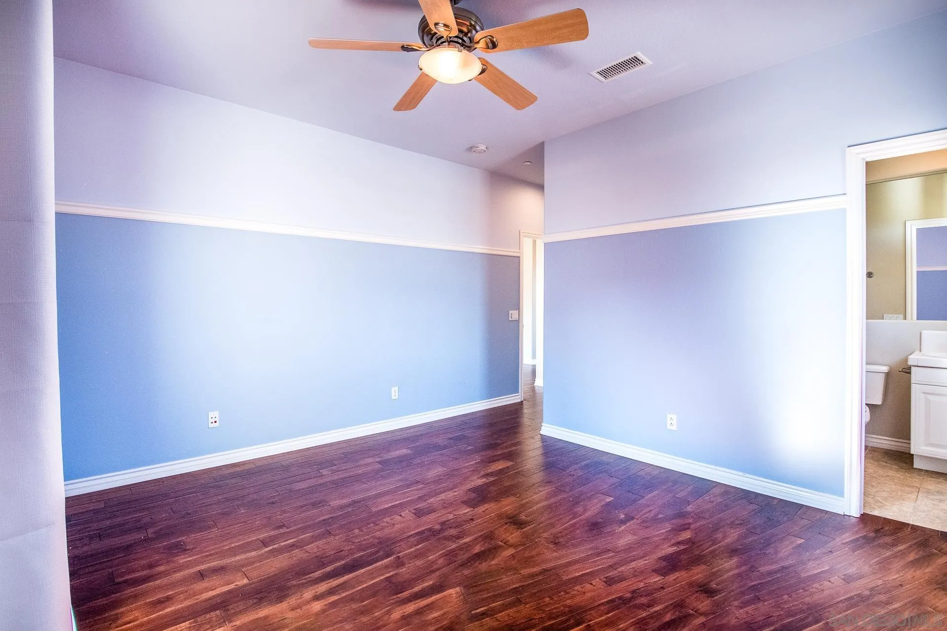1219 Vista De Lomas Bonsall, CA 92003 - Photo 25 of 47 a view of a room with wooden floor and a ceiling fan
