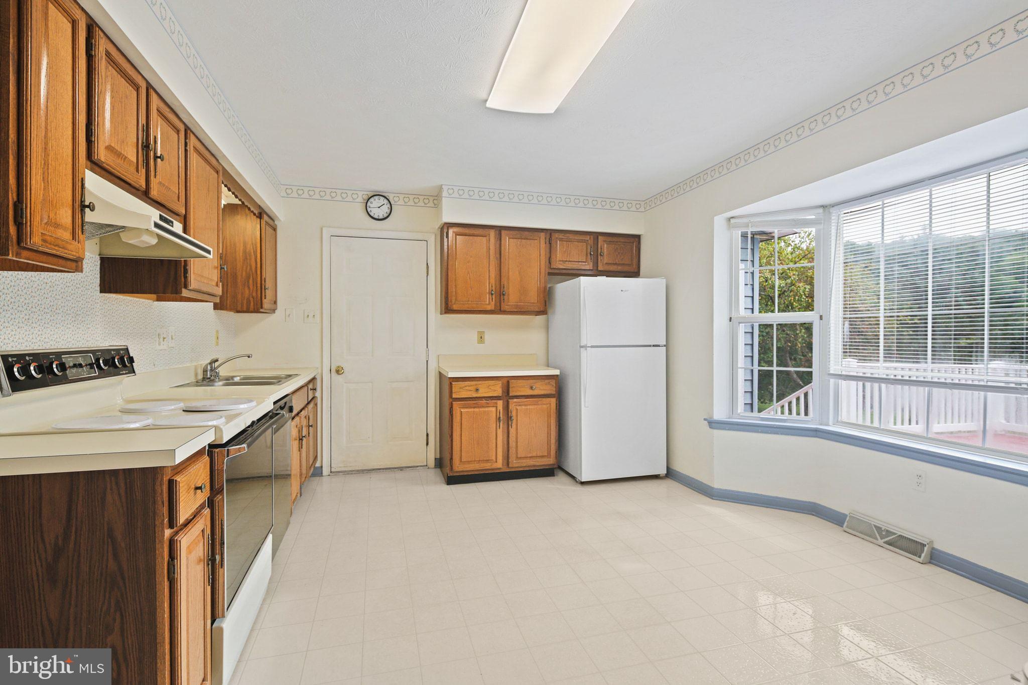61 Marhill Court Westminster, MD 21158 - Photo 5 of 33 a kitchen with white cabinets and white appliances