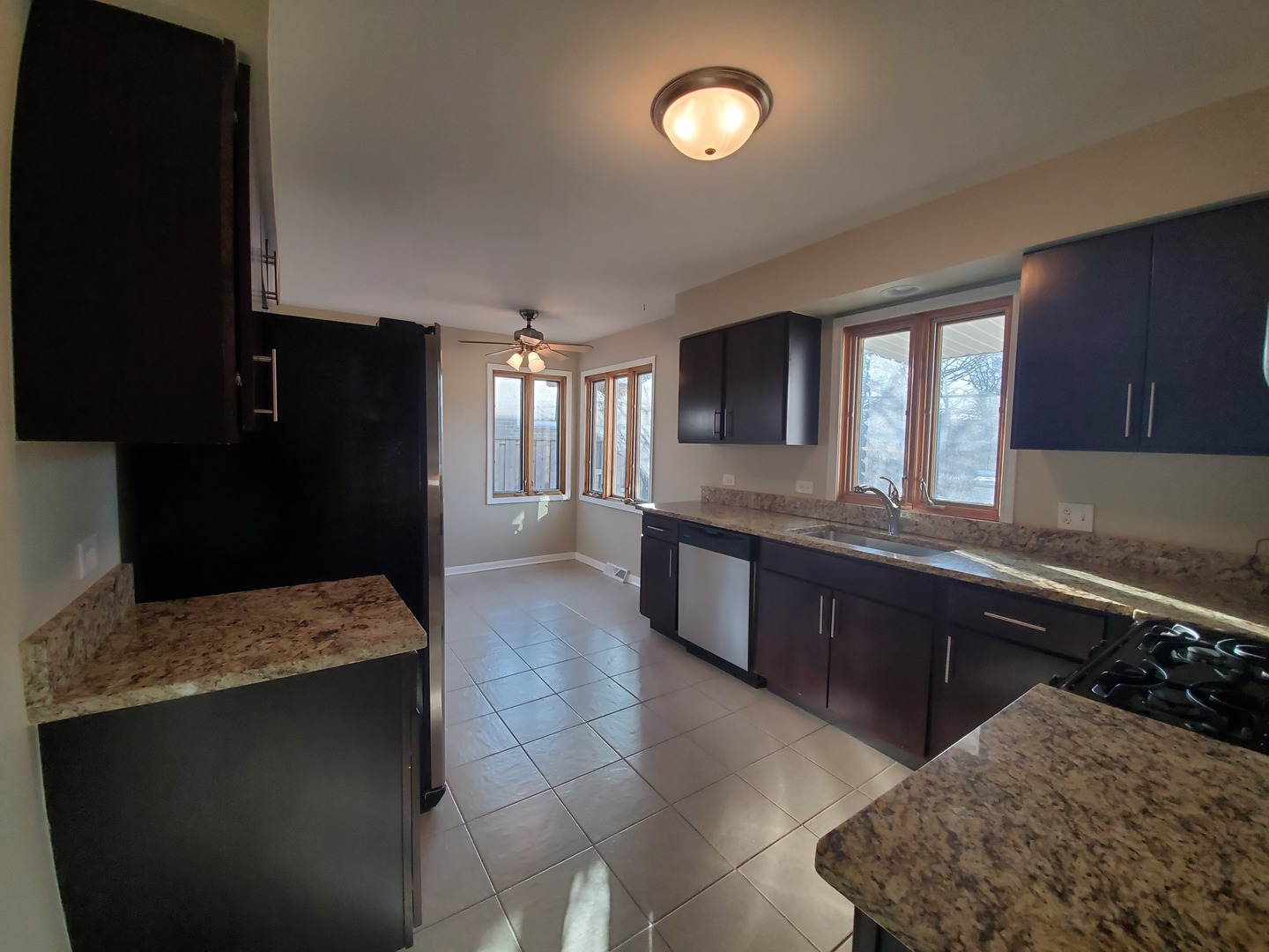 1695 Clavey Road Highland Park, IL 60035 - Photo 8 of 24 a large kitchen with kitchen island granite countertop a sink and a stove top oven