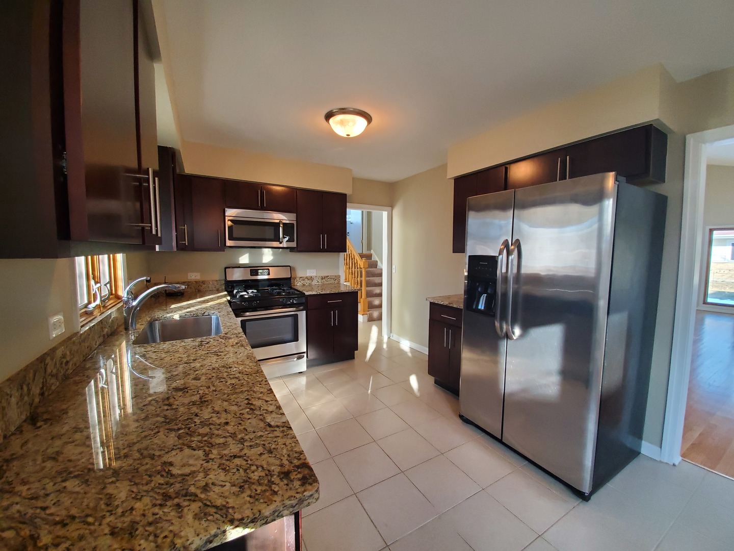 1695 Clavey Road Highland Park, IL 60035 - Photo 10 of 24 a kitchen with granite countertop a refrigerator and a sink