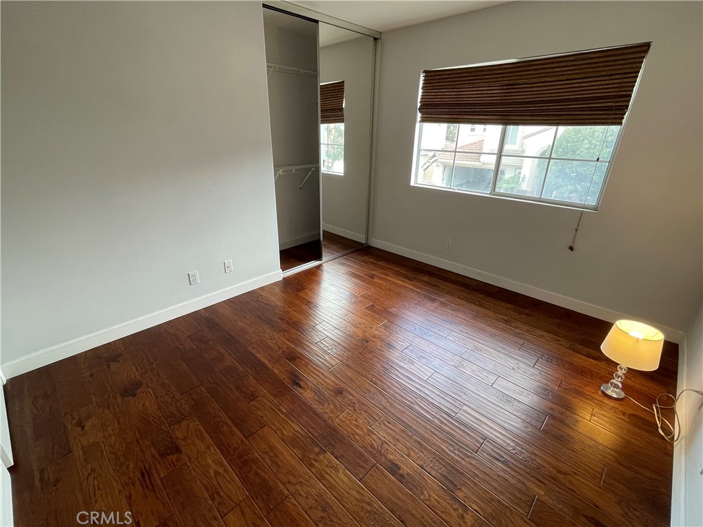 3095 Promenade Costa Mesa, CA 92626 - Photo 6 of 10 an empty room with wooden floor and windows