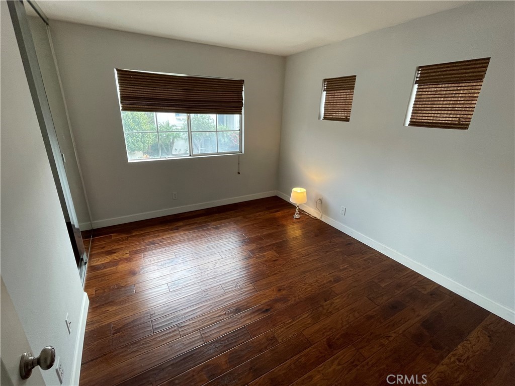3095 Promenade Costa Mesa, CA 92626 - Photo 7 of 10 a view of an empty room with wooden floor and a window