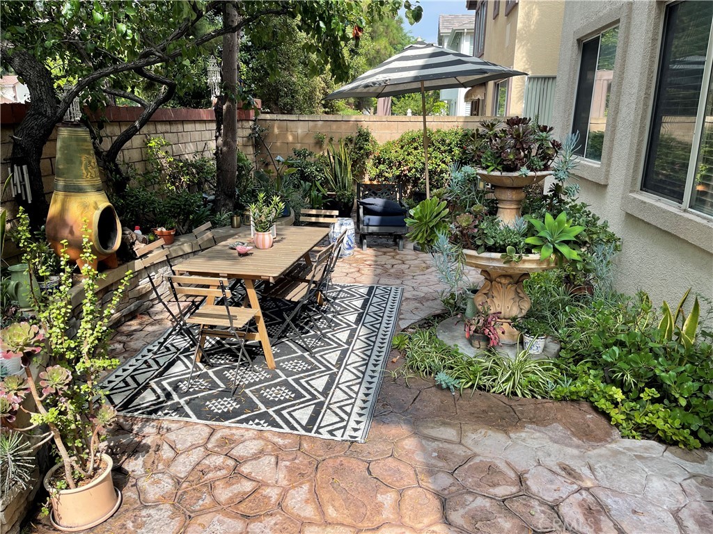 3095 Promenade Costa Mesa, CA 92626 - Photo 10 of 10 a view of a patio with table and chairs and potted plants