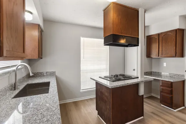 a kitchen with stainless steel appliances granite countertop a stove a sink and a microwave