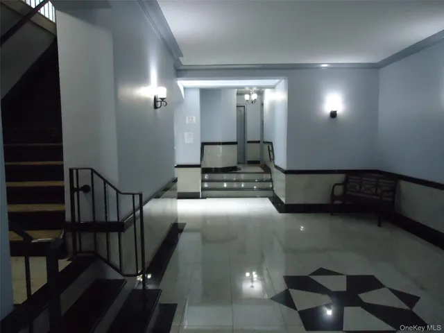 a lobby with furniture and stairs