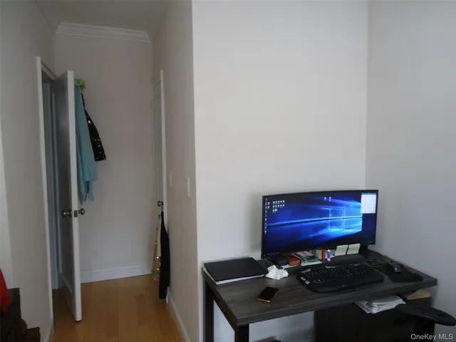 a view of hallway with chair and wooden floor