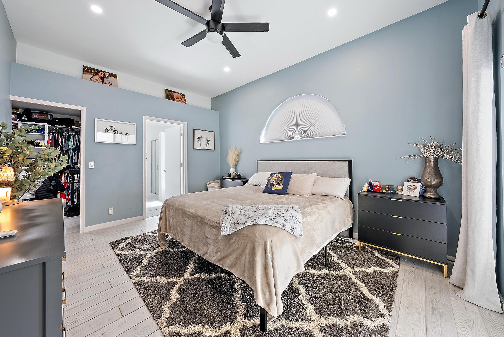 159 St Michaels Court Jupiter, FL 33458 - Photo 12 of 22 a bedroom with a bed and a mirror