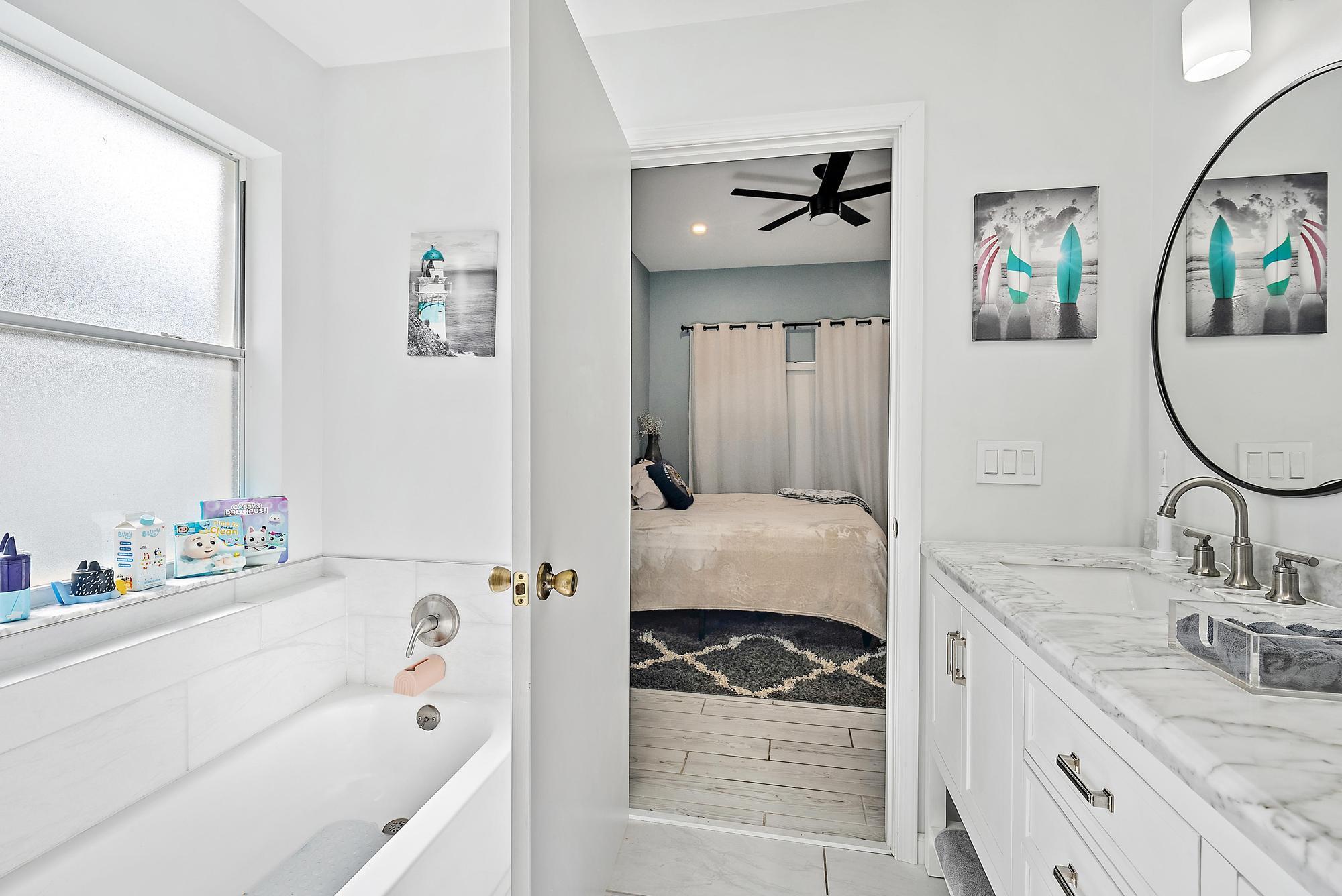 159 St Michaels Court Jupiter, FL 33458 - Photo 14 of 22 a en suite bathroom with a tub sink and mirror