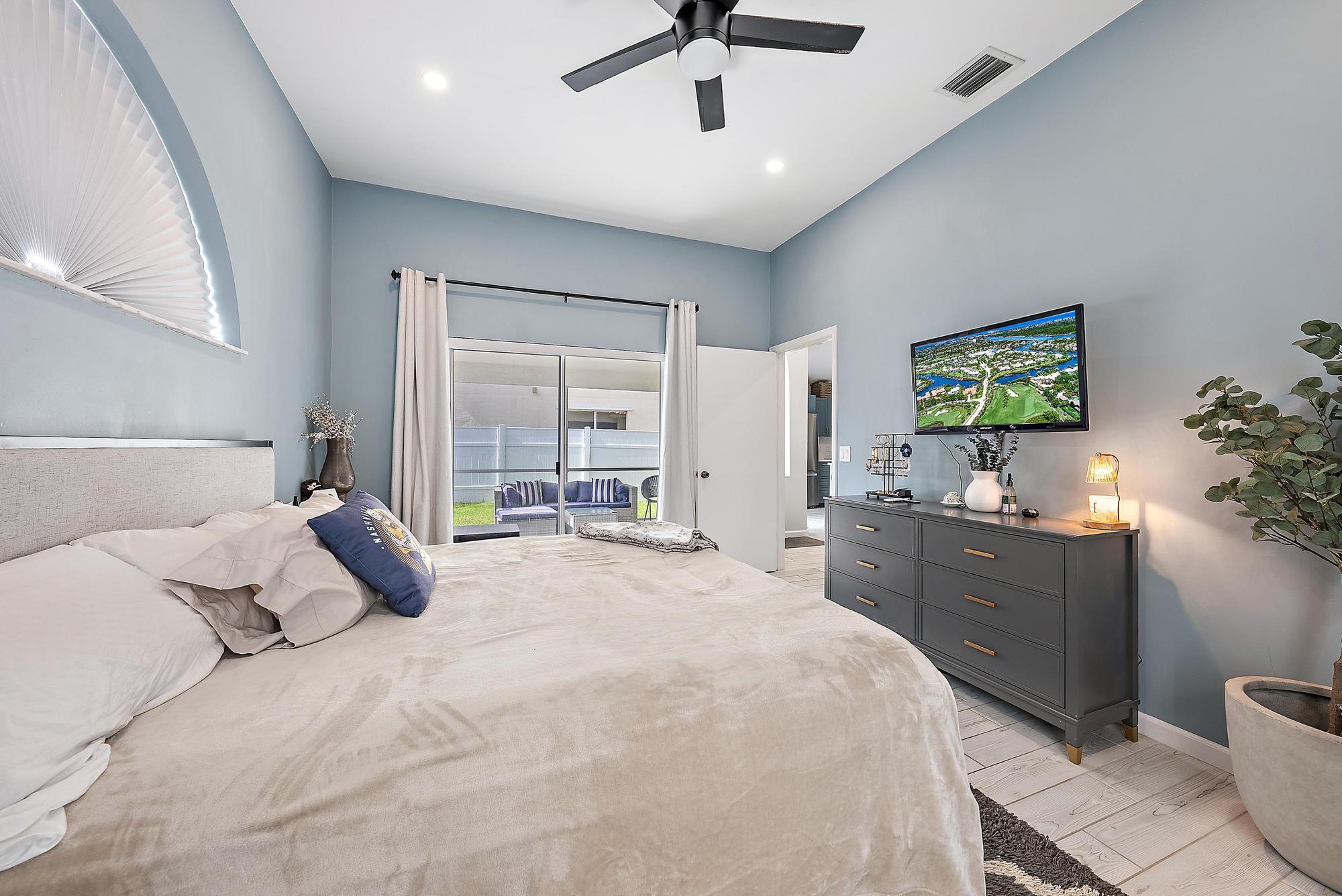 159 St Michaels Court Jupiter, FL 33458 - Photo 15 of 22 a bedroom with a bed and a dresser