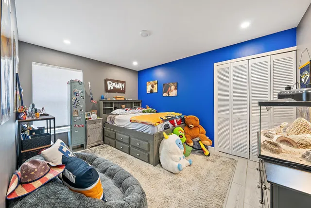 a bedroom with bed and a couch