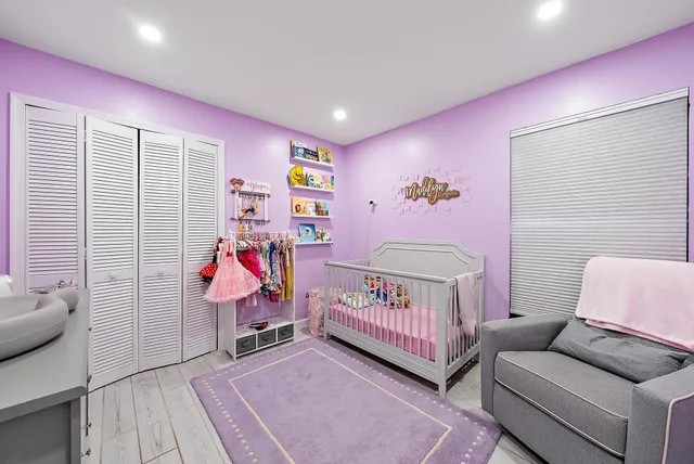 a bedroom with furniture and a baby crib