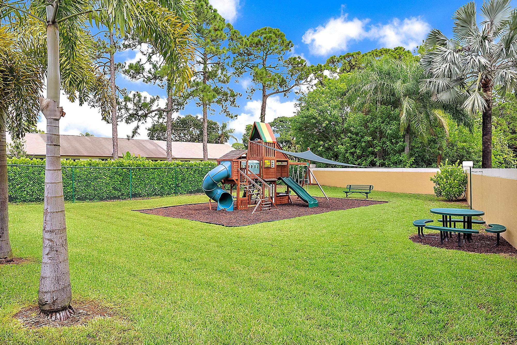 159 St Michaels Court Jupiter, FL 33458 - Photo 21 of 22 a view of a garden with a slide