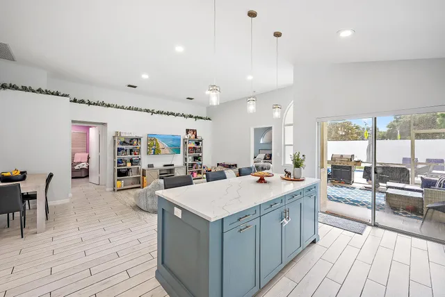 a large white kitchen with a large window and counter space
