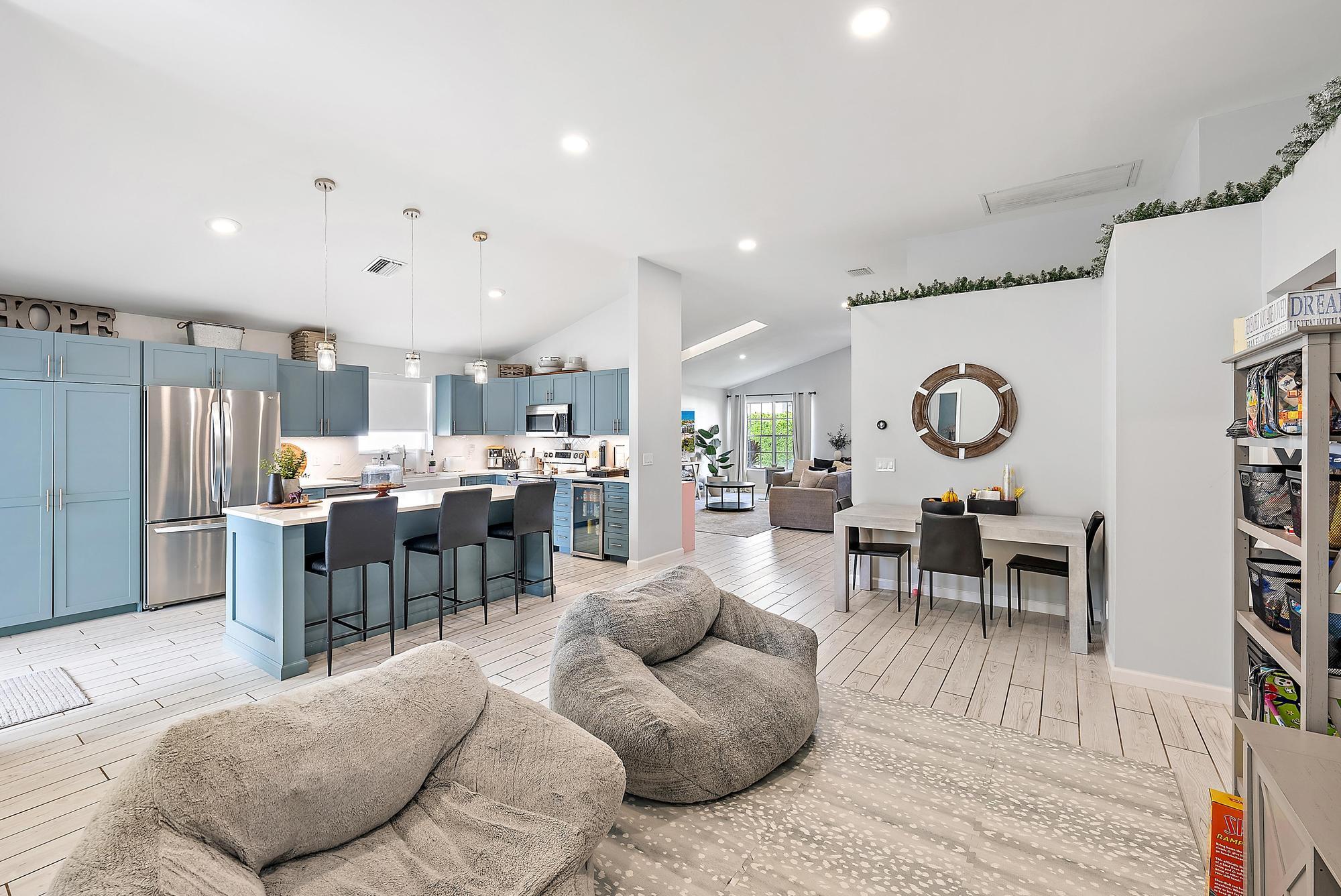 159 St Michaels Court Jupiter, FL 33458 - Photo 7 of 22 a living room with lots of furniture and kitchen view