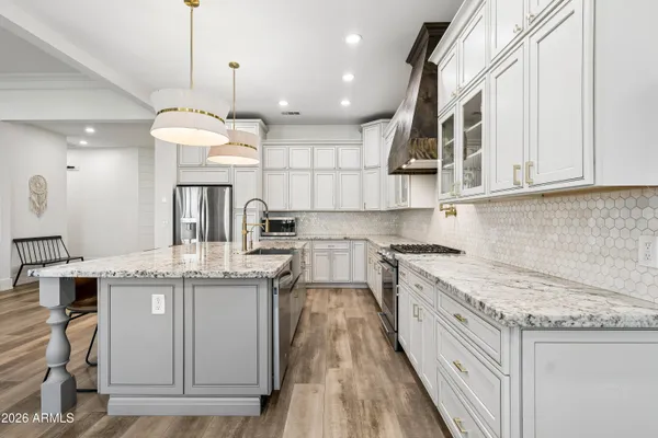 a stove top oven sitting inside of a kitchen