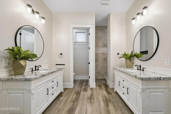 a bathroom with a granite countertop toilet sink and mirror