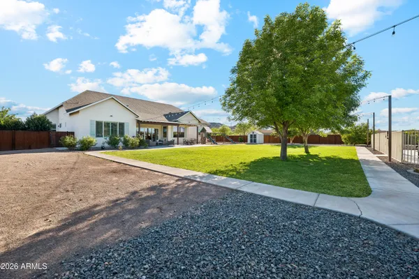 a view of a backyard with storage and utility