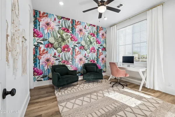 a living room with furniture fireplace and a large window
