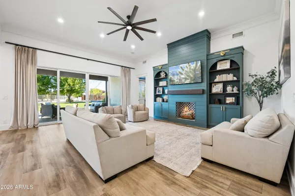 a living room with furniture and a wooden floor