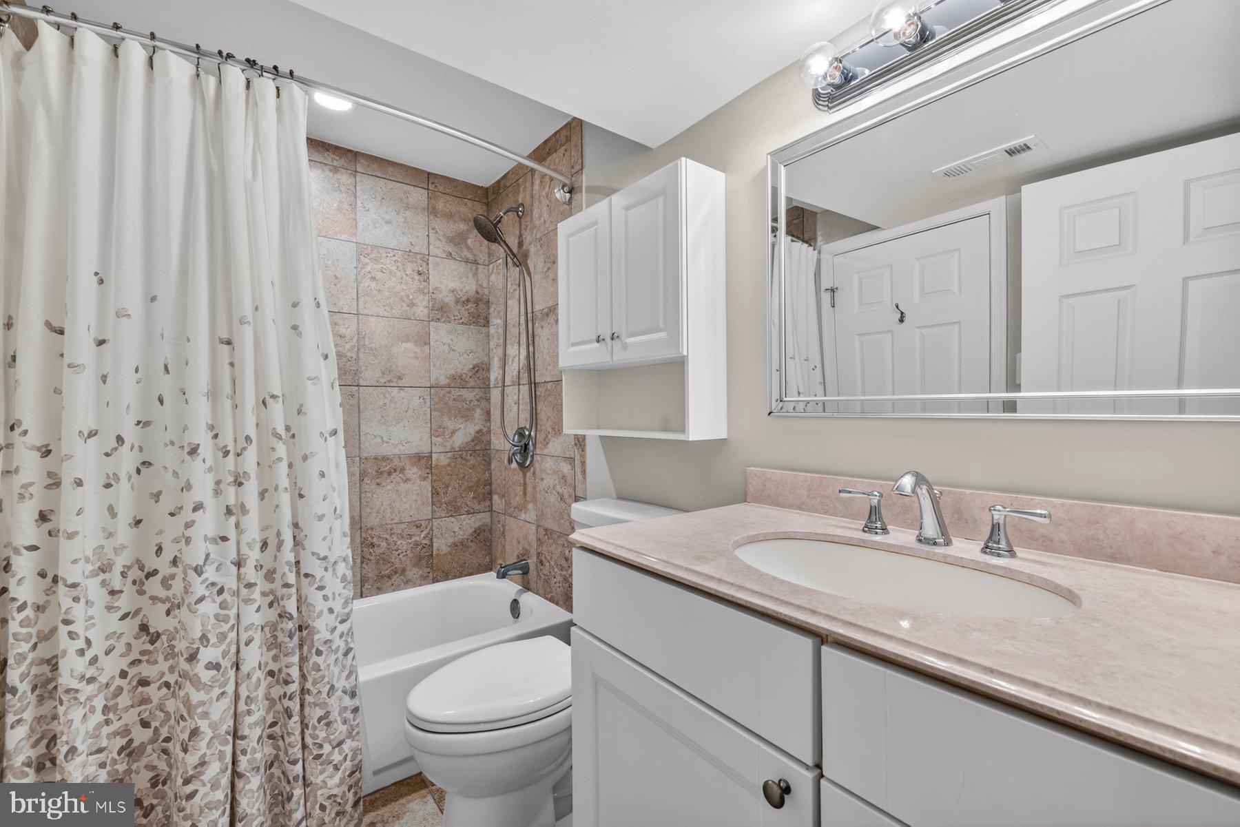 7518 Candytuft Court Springfield, VA 22153 - Photo 33 of 47 a bathroom with a granite countertop sink toilet and shower